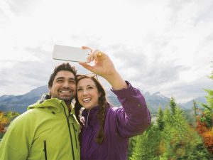 hikers taking selfie wtih cell phone